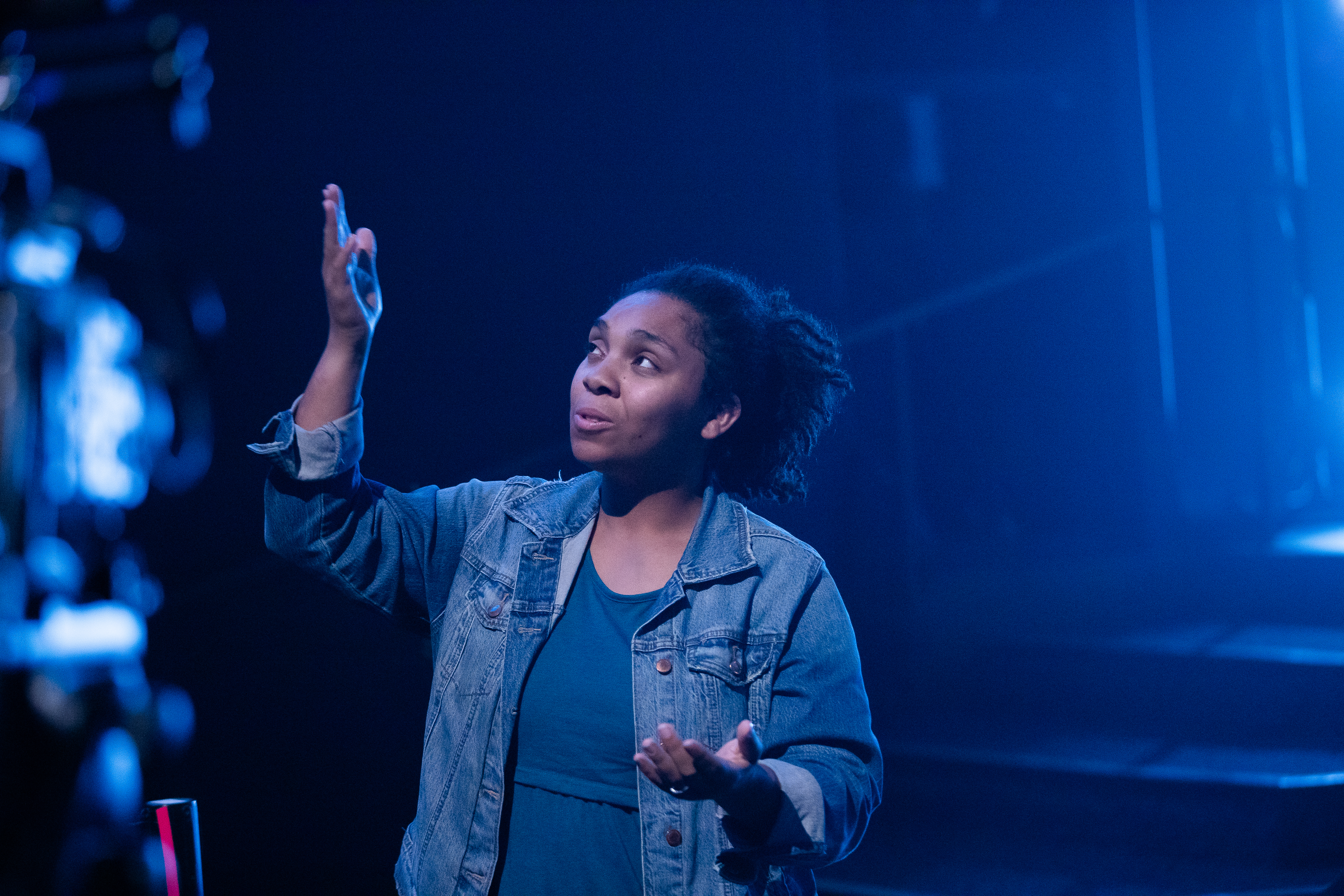 People standing around a woman in prayer