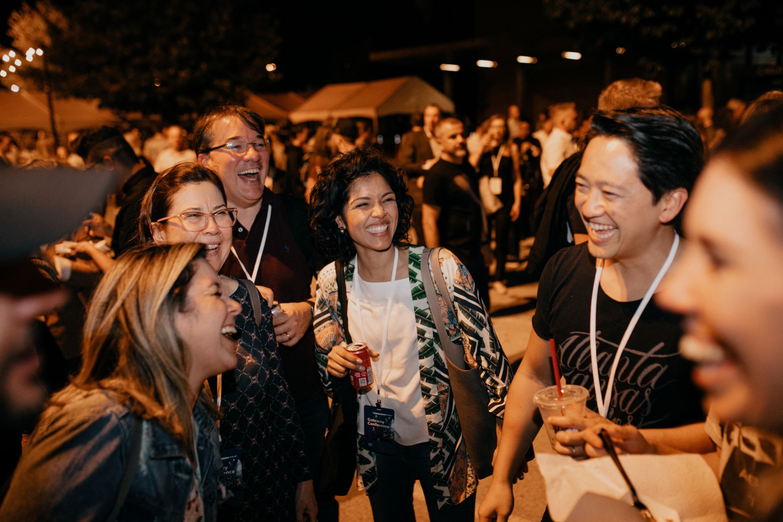 Man with hands up and eyes closed in a crowd